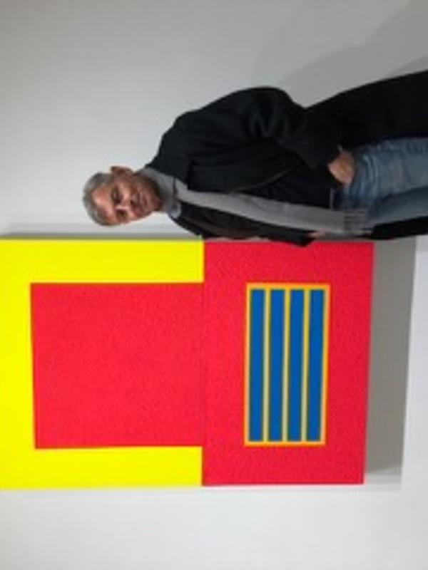 Professor Alfred Mac Adam standing in front of a red and yellow painting
