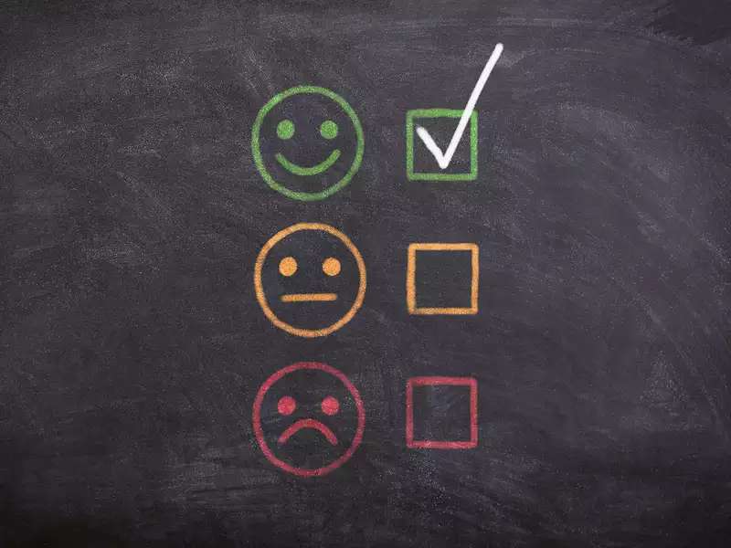 Chalkboard with a green smiley face and a checkmark, a neutral face and no checkmark, and a frowning face with no checkmark